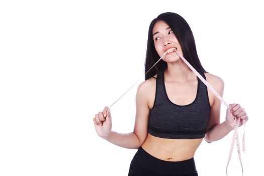 fitness woman biting measuring tape isolated on white background (diet concept)