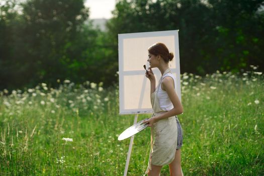 woman artist nature drawing art creative picnic. High quality photo