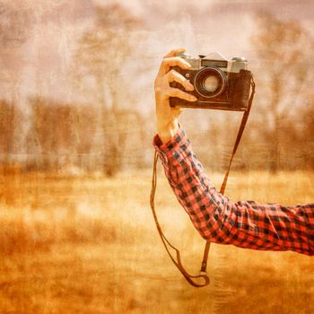 Female hand with vintage photo camera outdoor