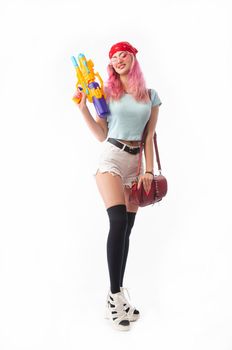 girl with a water gun in summer clothes, slim and sexy isolated on a white background