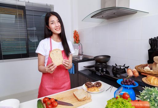 woman holding a bread in kichen room at home