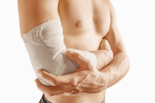 Man holds his elbow joint, injury the elbow
