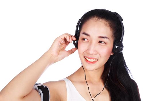 young smiling fitness woman listening to music with earphones isolated on a white background