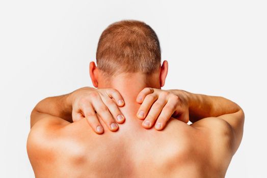 Unrecognizable man touches neck, pain in the neck, rear view, on a white background