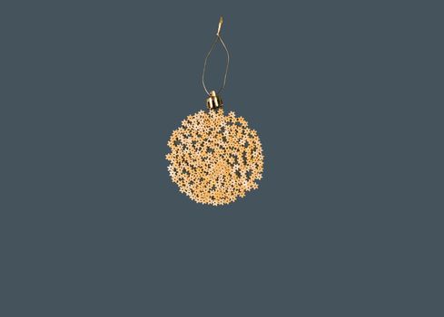 Christmas decoration on a tree in the form of a ball of pasta on a blue paper background, top view. Conceptual photo