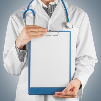 Man doctor holding a clipboard, space for text