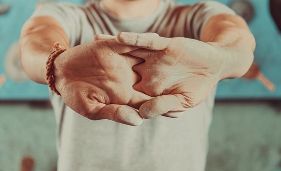 Man warming up his hands before climbing indoor