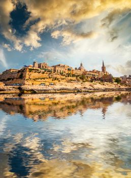 view on Valletta with its architecture from the sea with reflection