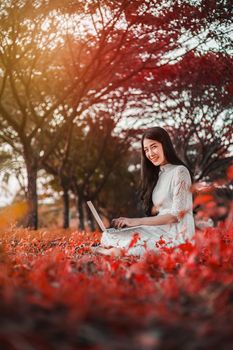 beautiful woman using laptop in the outdoor park