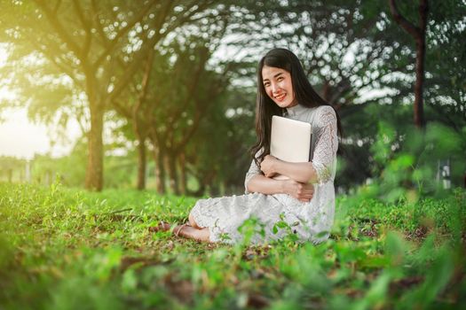 beautiful woman using laptop in the outdoor park