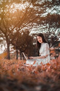 beautiful woman using laptop in the outdoor park