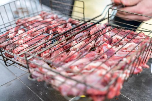 Lamb ribs cooked over an open fire, close-up in 4K. Lamb chops Grilling Barbecue, BBQ Originally made from lamb. Wire rack for roast lamb in the grill racks. The concept of traditional food on fire,