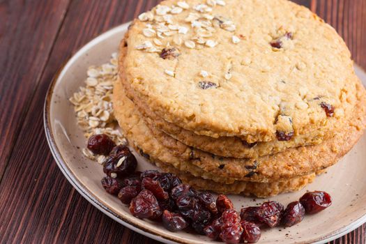 Oat cookies served on dark wooden table close up