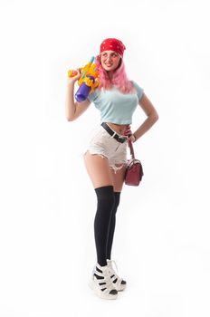 girl with a water gun in summer clothes, slim and sexy isolated on a white background
