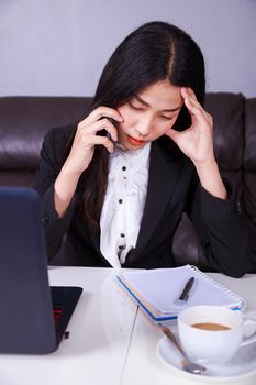woman in business suit working in stress desperate talking on a mobile phone 