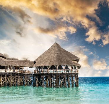 colorful landscape with african hotel in sea on the pier, Zanzibar