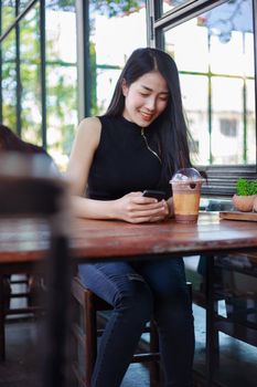 young woman using smartphone in the cafe