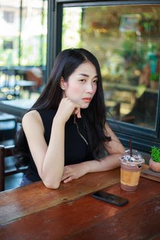 beautiful woman with ice chocolate in the cafe