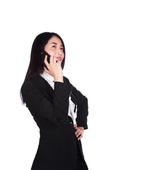 Cheerful young business woman in suit and talking on a mobile phone