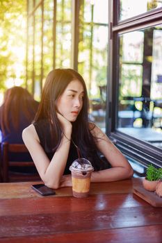 beautiful woman with ice chocolate in the cafe