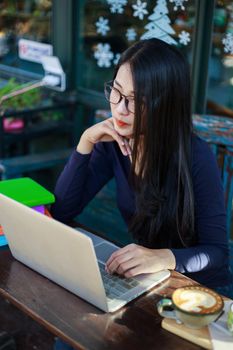 beautiful woman working with laptop in the cafe