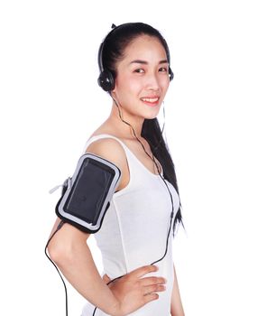 young smiling fitness woman listening to music with earphones isolated on a white background