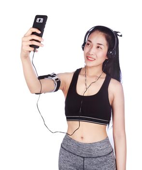 sporty woman making selfie photo on smartphone isolated on a white background