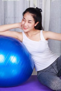 sport woman doing yoga exercise with fitness ball