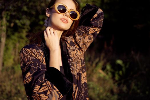 pretty woman wearing sunglasses outdoors fashion nature. High quality photo