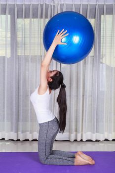 sport woman doing yoga exercise with fitness ball