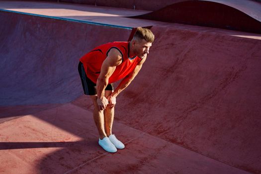 sports man doing exercises on the sports field fitness. High quality photo