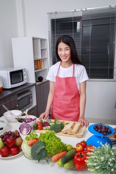 young beautiful woman cooking in kitchen room at home