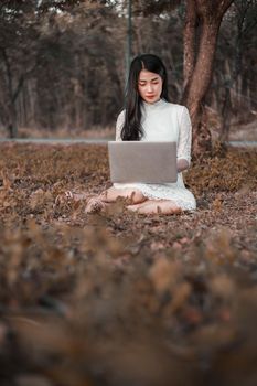 beautiful woman using laptop in the outdoor park