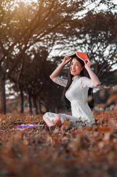 young woman holding a book in the park