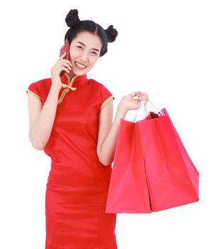 woman holding shopping bag and using mobile phone in concept of happy chinese new year isolated on a white background
