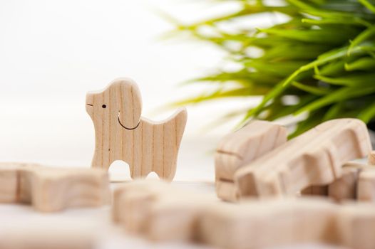 cute wooden toy animal over white background, tiny toys and shallow depth of field