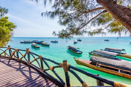 amazing landscape with turquoise ocean and african boats from a terrace of a hotel
