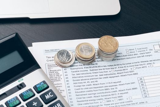 avings, finances, economy and home concept - close up of calculator counting money and making notes at home