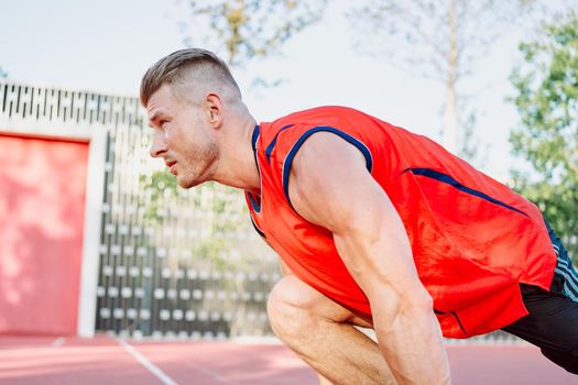 athletic man on sports ground workout exercise crossfit summer. High quality photo