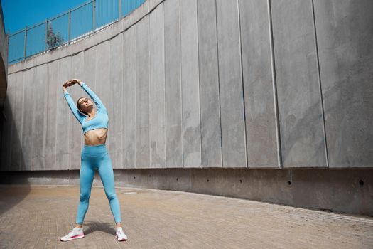 Beautiful fit young woman jogger is running outdoors