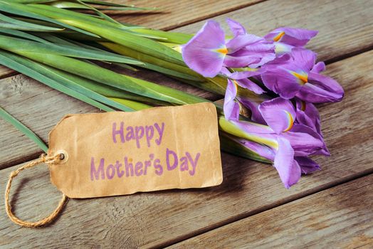Bouquet of flowers Irises and the card with the inscription Happy Mother’s Day