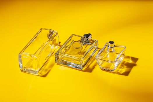 perfume glass bottle on light yellow background. Eau de toilette