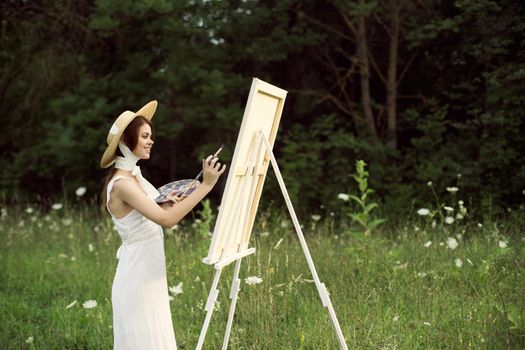 cheerful woman outdoors drawing art landscape hobby. High quality photo