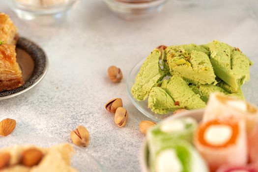 Close up photo of colorful Turkish halva sweets on gray surface