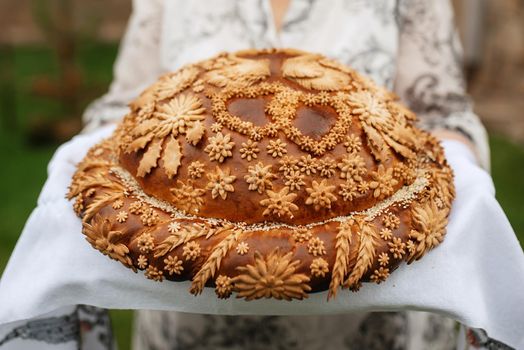 wedding bread loaf with voluminous twisted pigtails and decorations