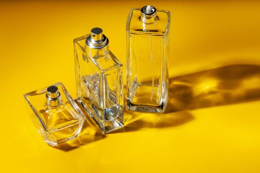 perfume glass bottle on light yellow background. Eau de toilette