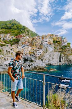 Manarola village, Cinque Terre park Italy during a summer day, vacation Italy colorful coast Manarola Cinque Terre Italy. Man watching the sunset