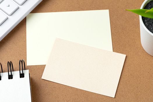 Blank business cards with supplies and keyboard on office table. Close up.