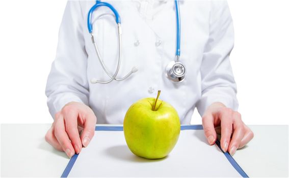 Apple on list, on the background of a woman doctor