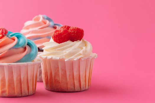 Yummy sweet cupcakes on light pink background